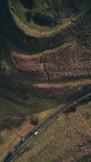 aerial of hills and grass with road