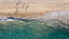 aerial photo of a beach and aqua blue water