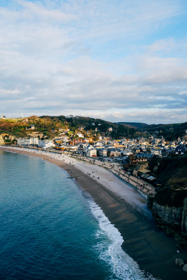 aerial photo of a town next to a sandy beach