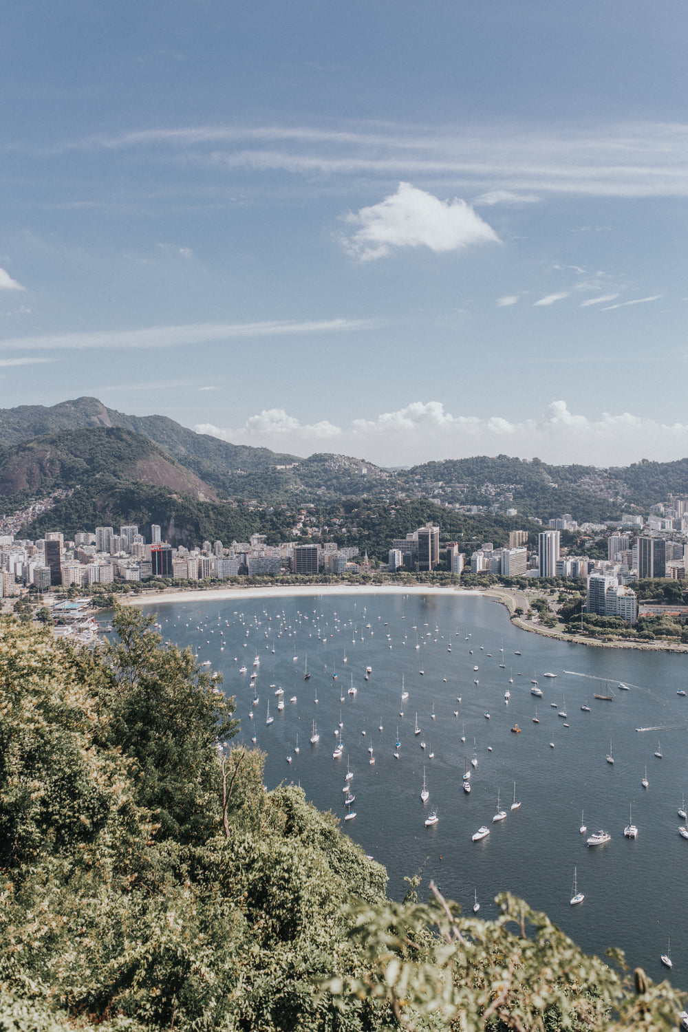 aerial photo of boats in water next to a city coastline