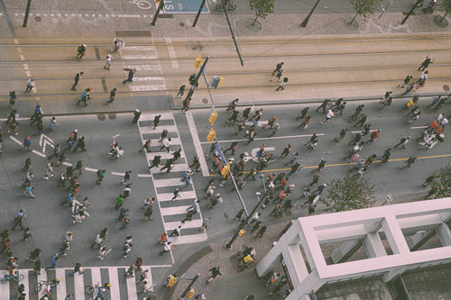 aerial photo of crowd walking on a city street