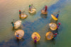 aerial photo of people stands in a circle in water