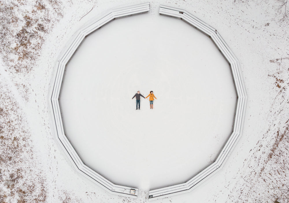 aerial view of a couple making snow angels