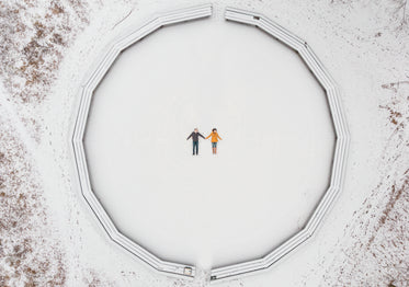 aerial view of a couple making snow angels