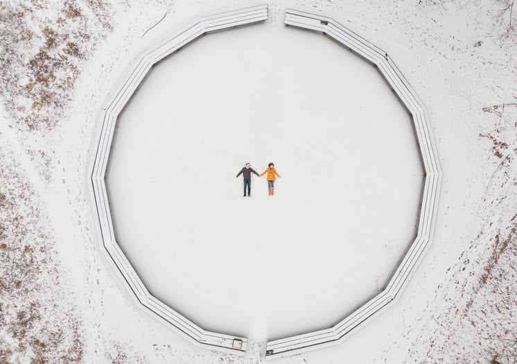 Aerial View Of A Couple Making Snow Angels