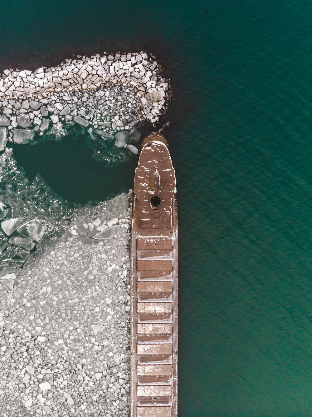 aerial view of a ship surrounded by ice