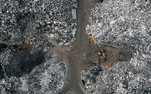 aerial view of metal recycling facility with backhoe