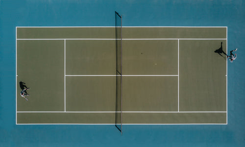 aerial view of two people playing tennis in the sun
