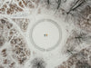 aerial view of two snow angels surrounded by trees