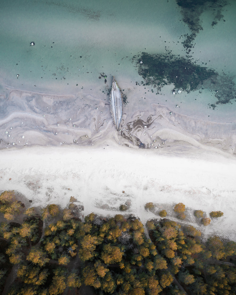 aerial view of white sand and blue water