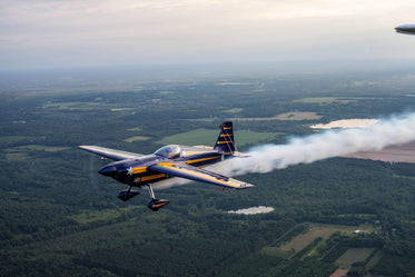 aerobatic plane in flight leaving behind a white trail