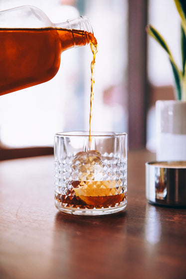 aged bourbon poured on rocks