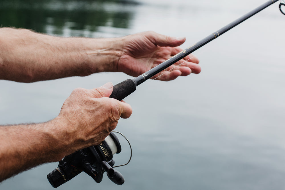 https://burst.shopifycdn.com/photos/aged-hands-hold-a-fishing-rod-over-still-waters.jpg?width=1000&format=pjpg&exif=0&iptc=0