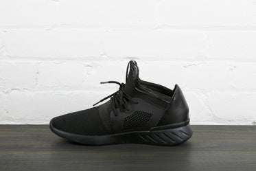 all black sneaker right foot