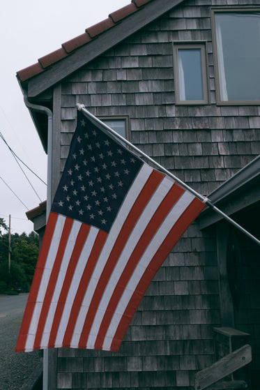 american flag on beach cottage