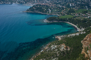 an aerial view of clear blue water by the shore