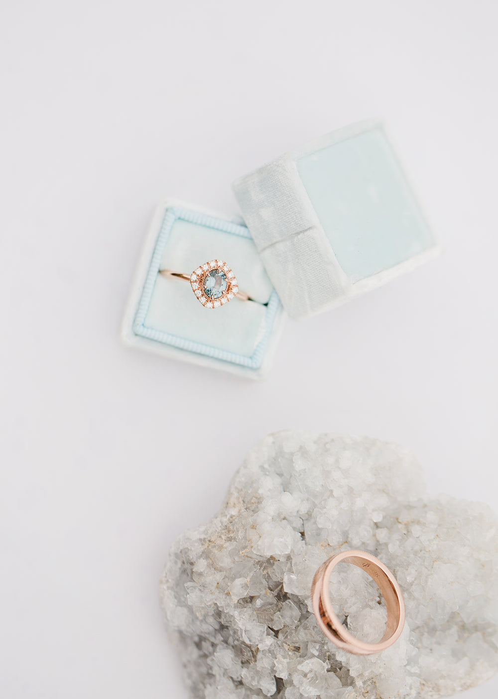 an engagment ring sits in a blue box