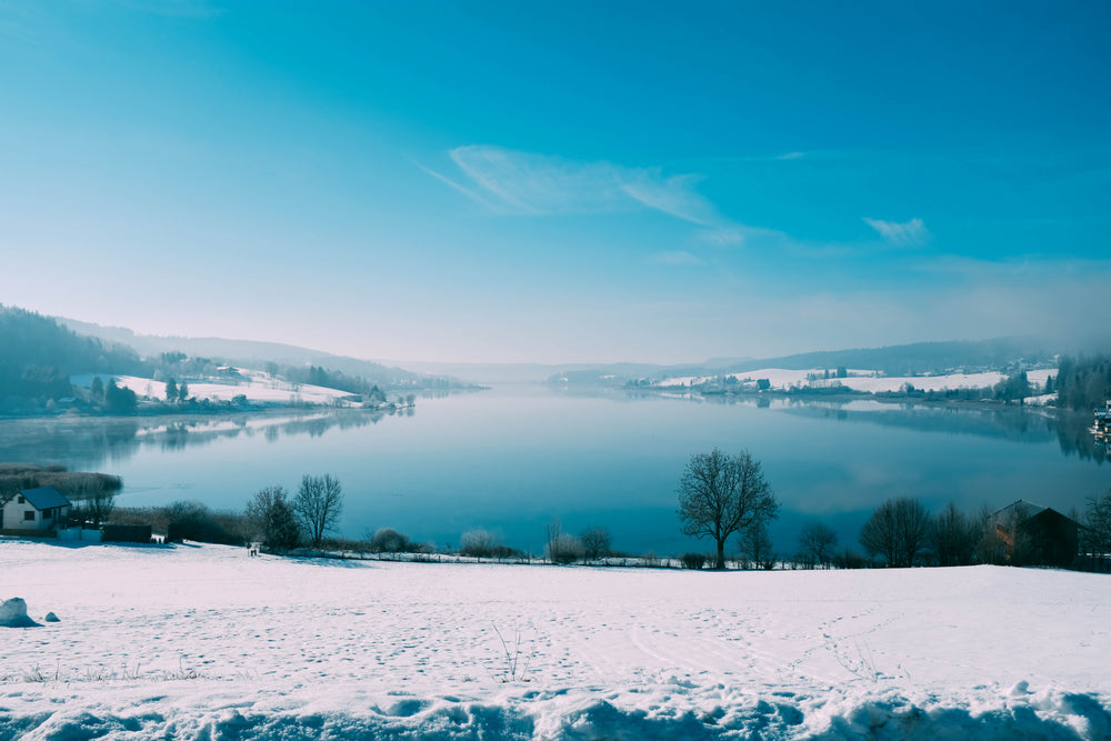 an icy blue lake framed by snowy sides