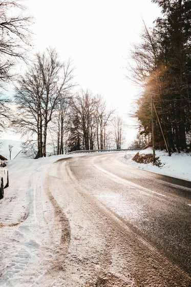 an icy highway and frosty trees in winter light