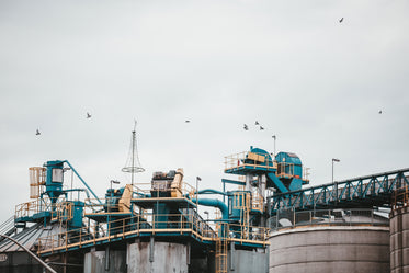 an industrial complex underneath a grey sky