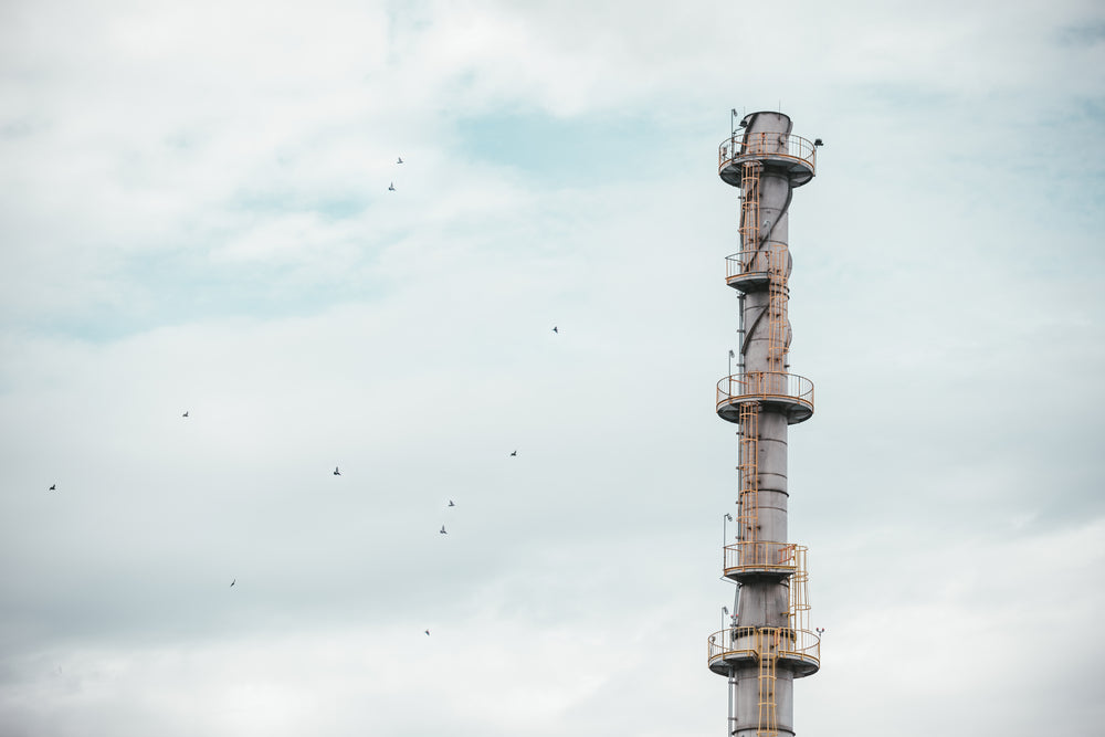 an industrial tower against a grey sky