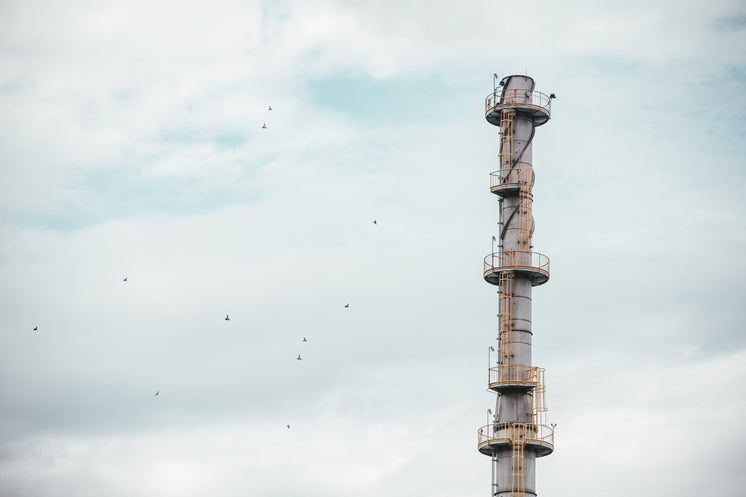 An Industrial Tower Against A Grey Sky