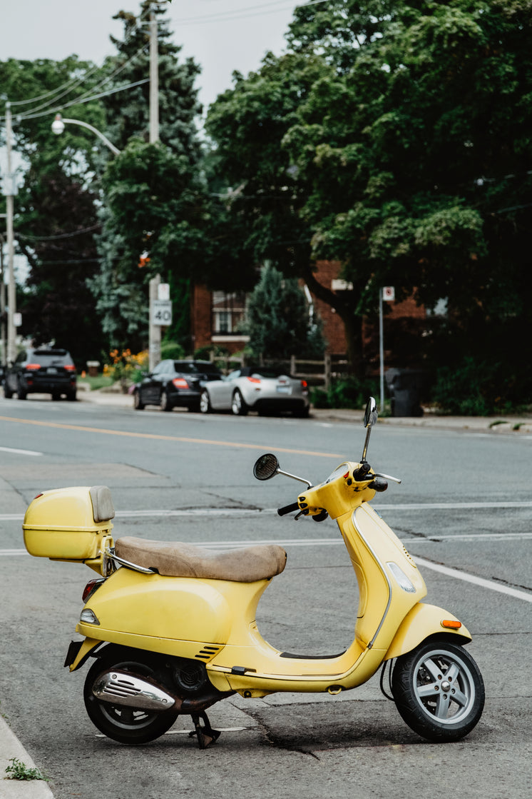 an-italian-summery-yellow-moped-parked-o