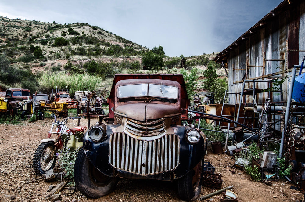 an old chevrolet in a desert graveyard