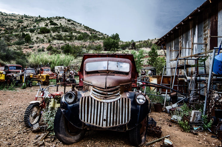 An Old Chevrolet In A Desert Graveyard