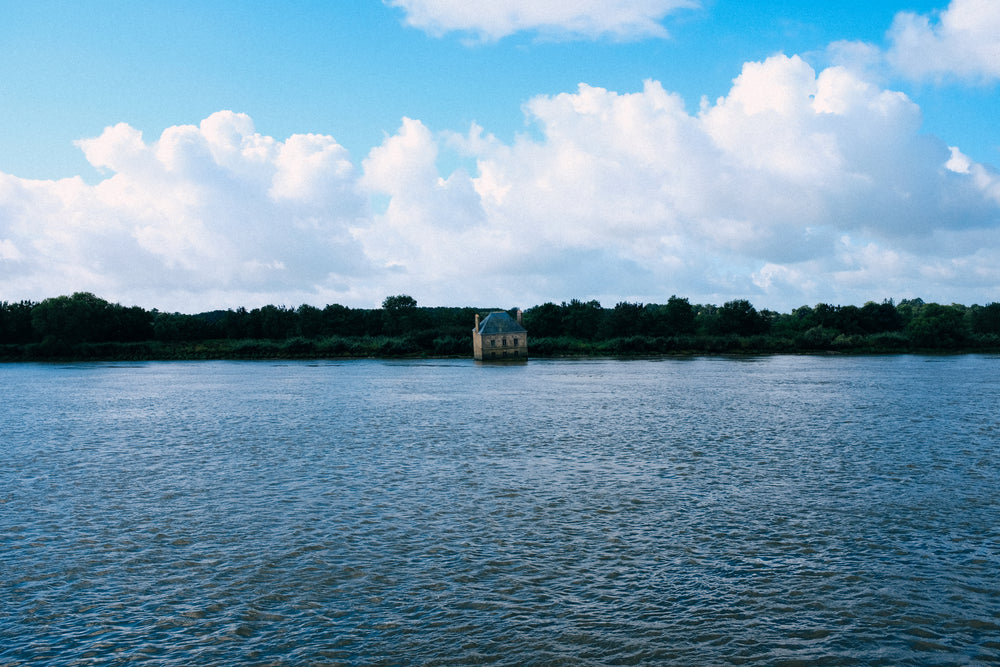 an old rustic building sinks into blue water