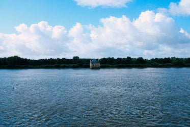 an old rustic building sinks into blue water