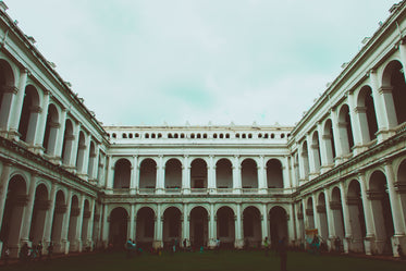 an open courtyard lined with two storeys of marble archways