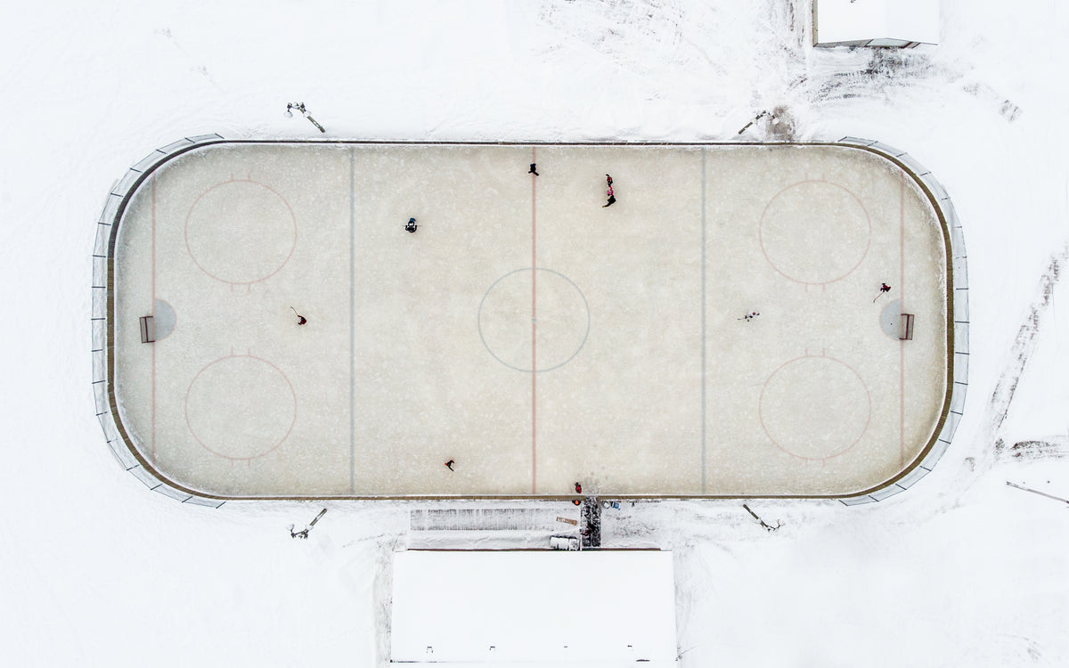 an overhead view of a small town neighborhood hockey rink