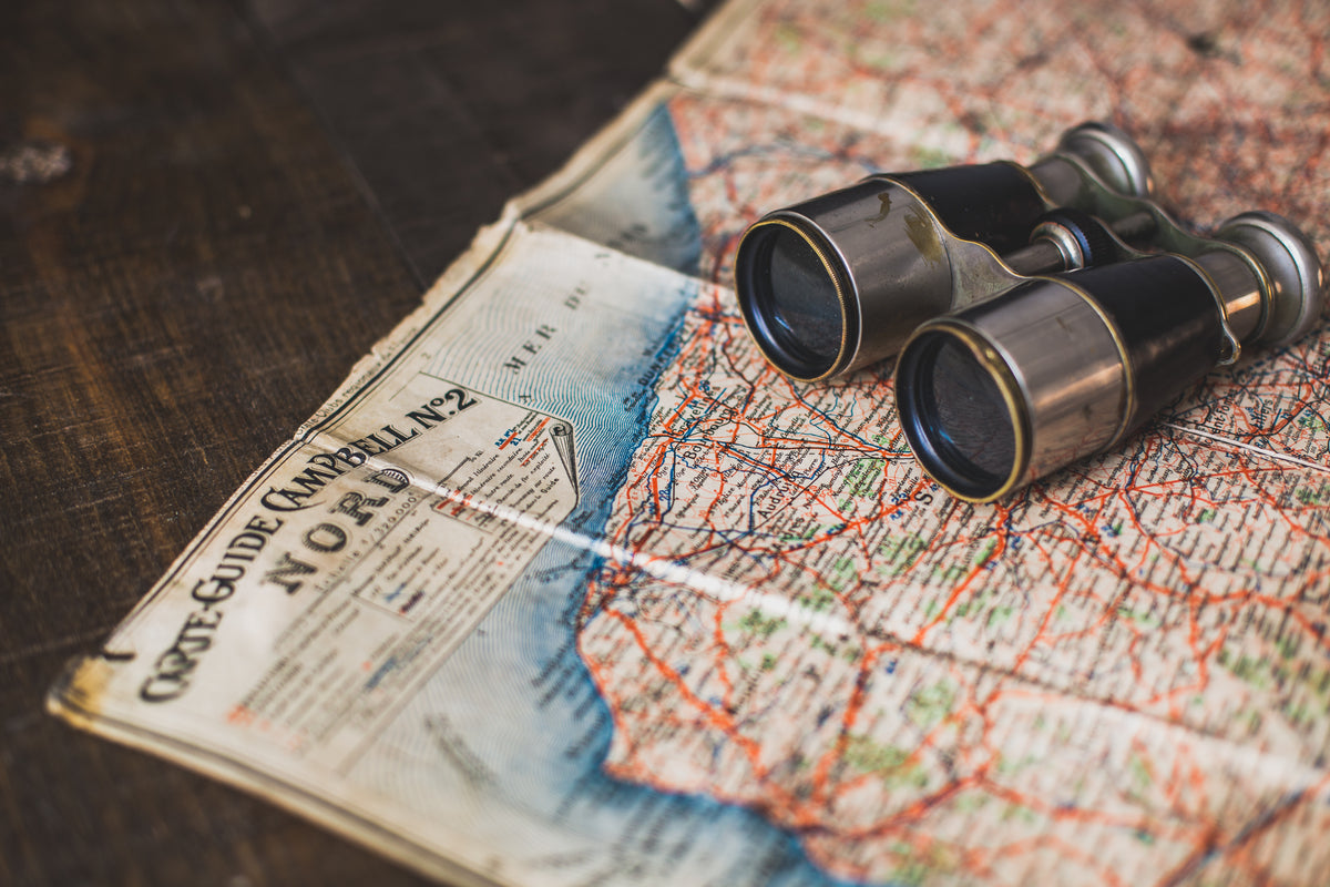 antique binoculars and map