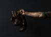 antique boxing gloves in hand