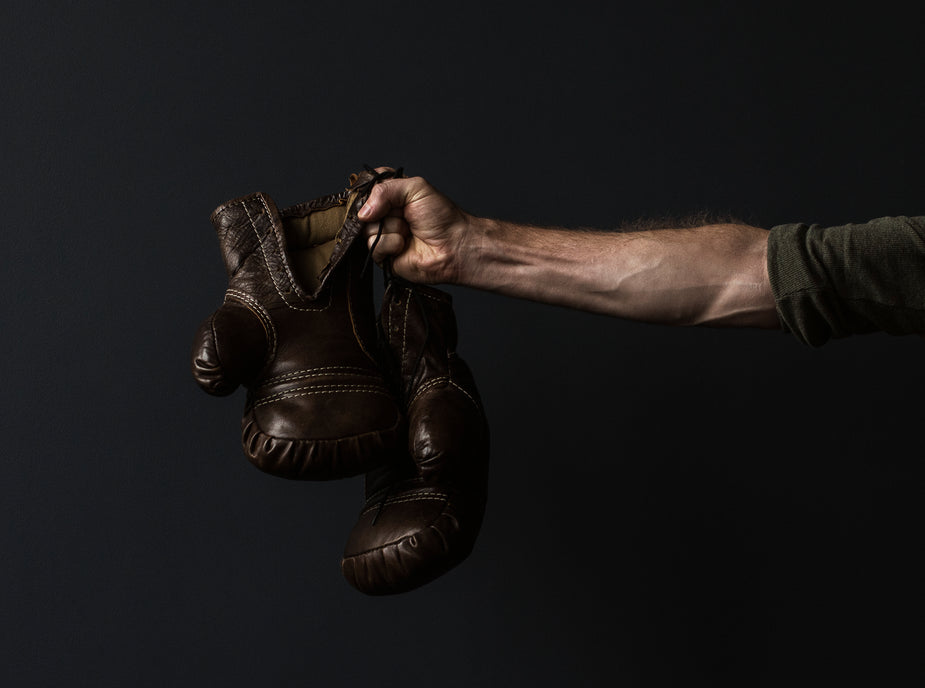 Picture of Antique Boxing Gloves In Hand — Free Stock Photo