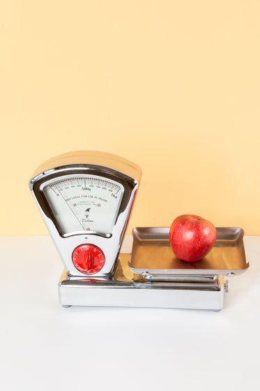 antique kitchen scale weighing apple