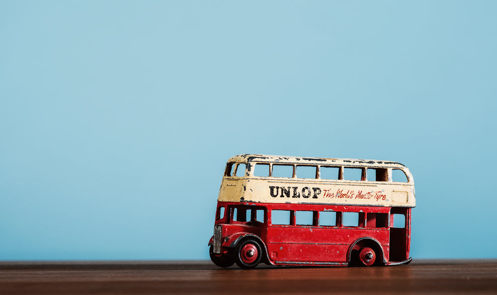 antique toy bus with flat tire