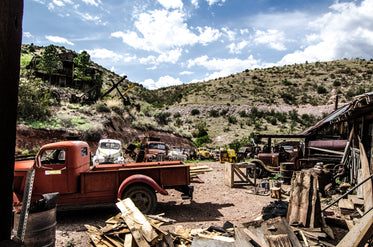 antique vehicles in a scrap yard