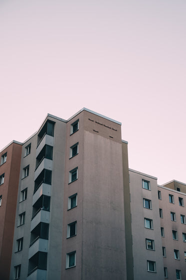 apartment building below pink sky