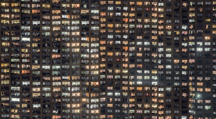 apartment-building-windows-glowing.jpg?w