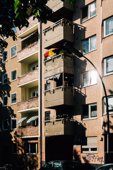 apartment building with balconies and green leaves