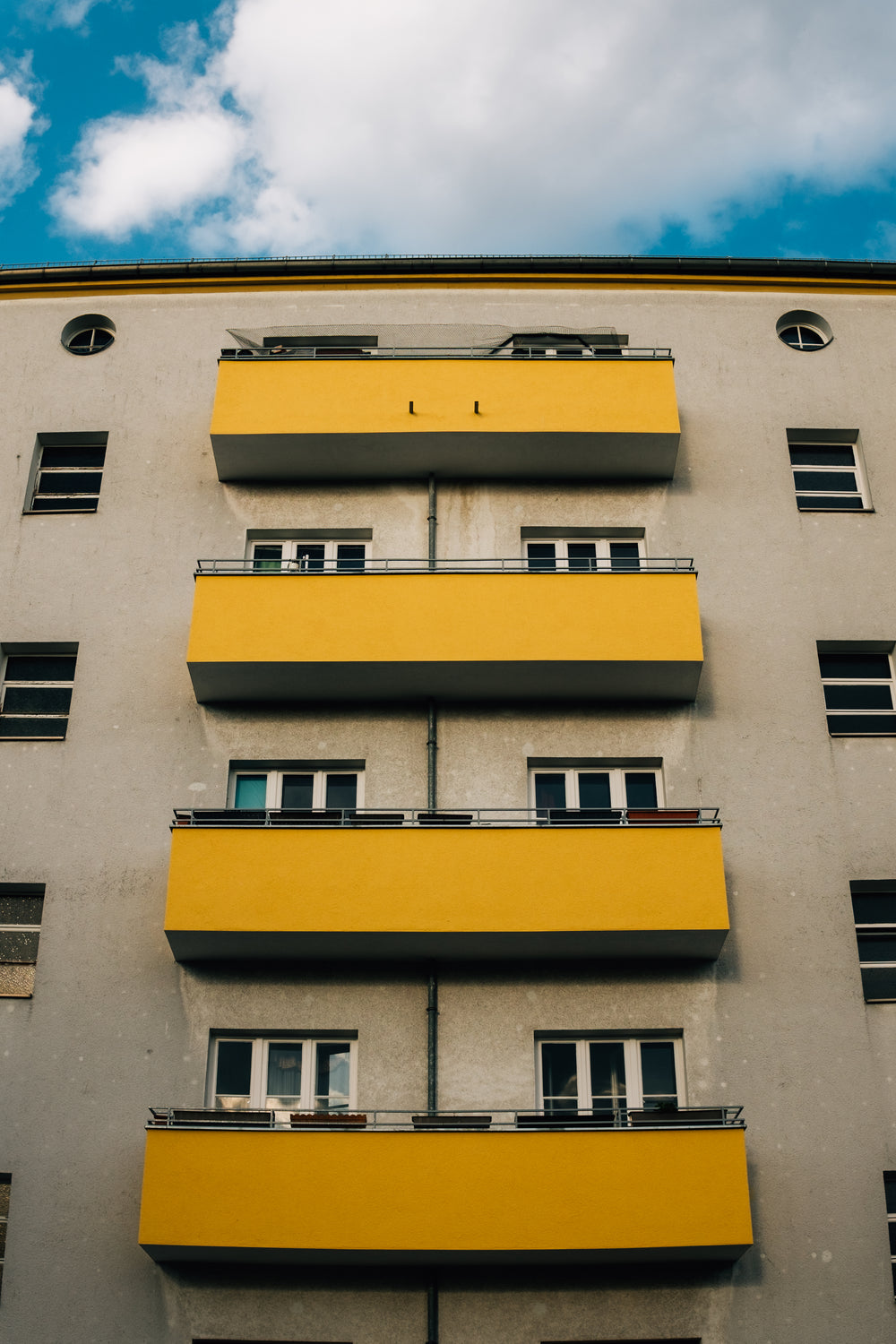 apartment building with yellow balconies