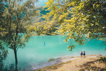 aqua blue river surrounded by trees