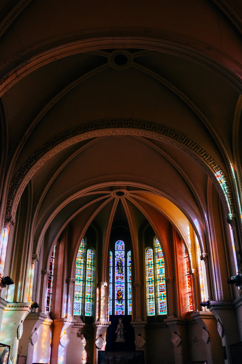 arched interior of a building with stained glass