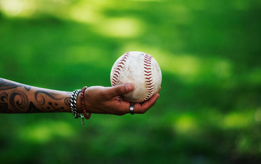 arm reaches out holding softball