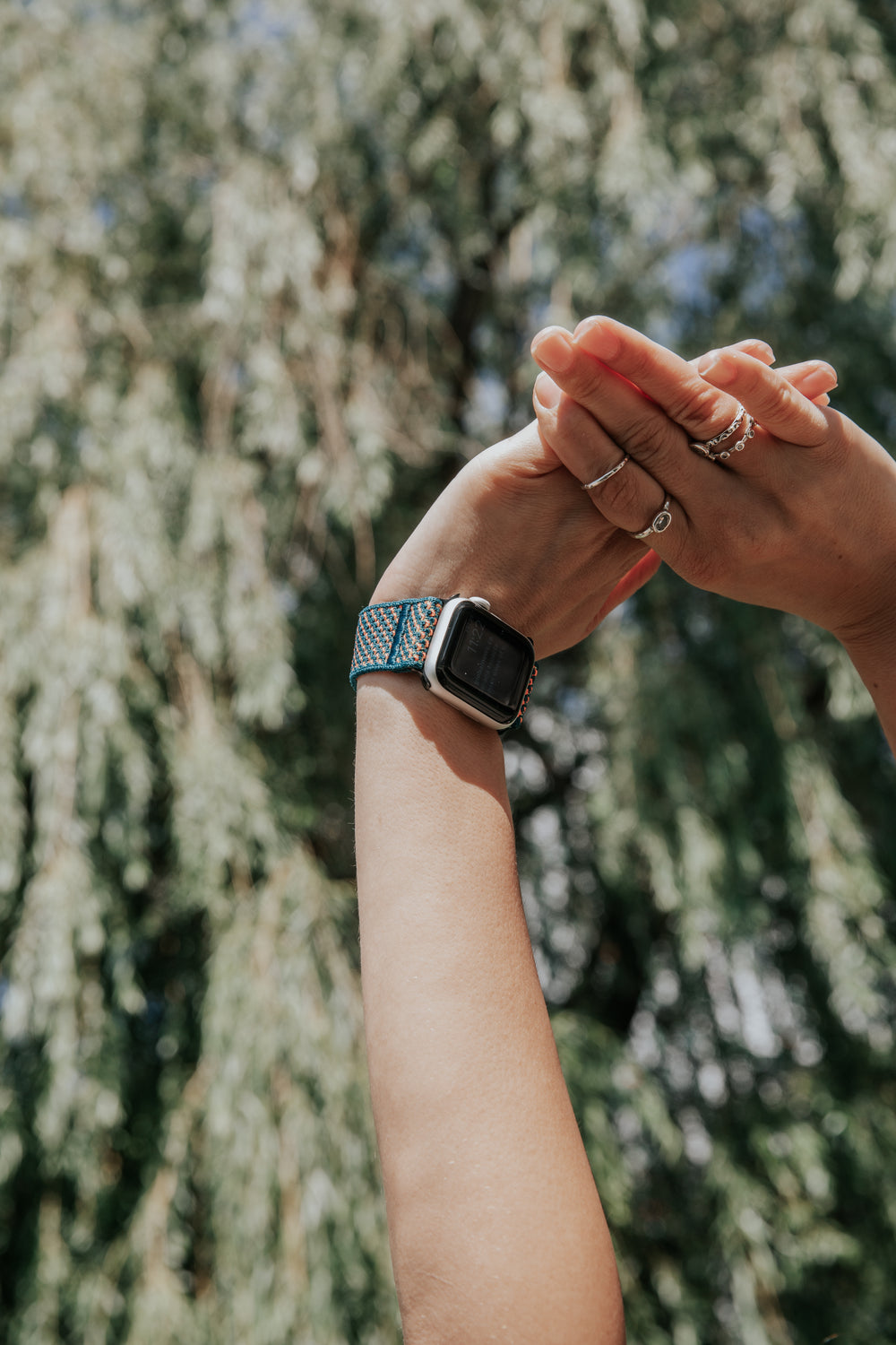 arms reach up with a smart watch on