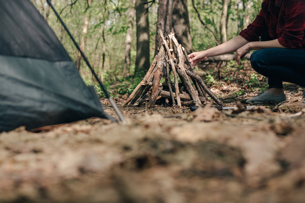 arranging sticks for a campfire