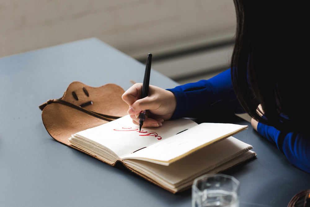 artist writing sale in notebook