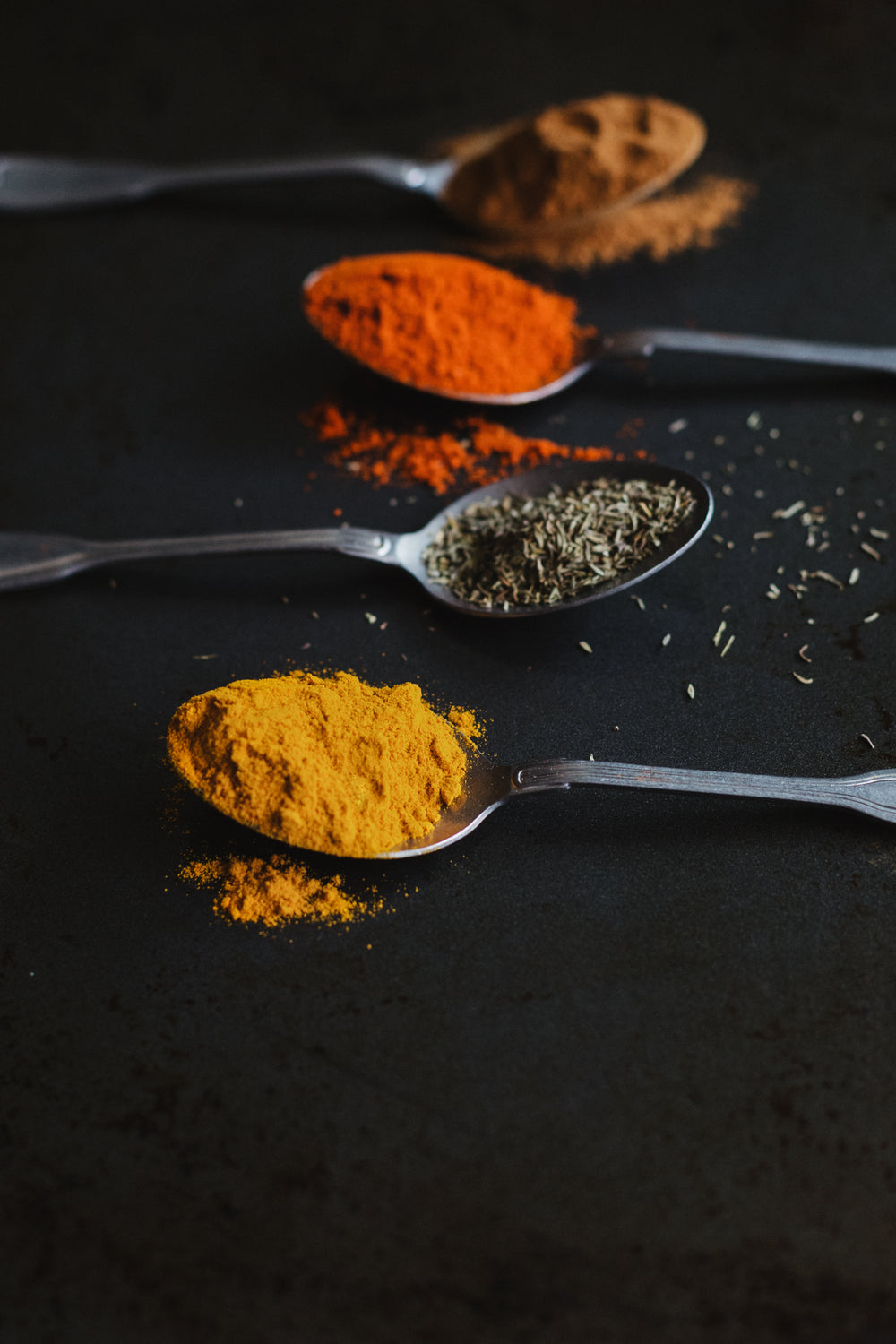 assorted cooking spices in spoons